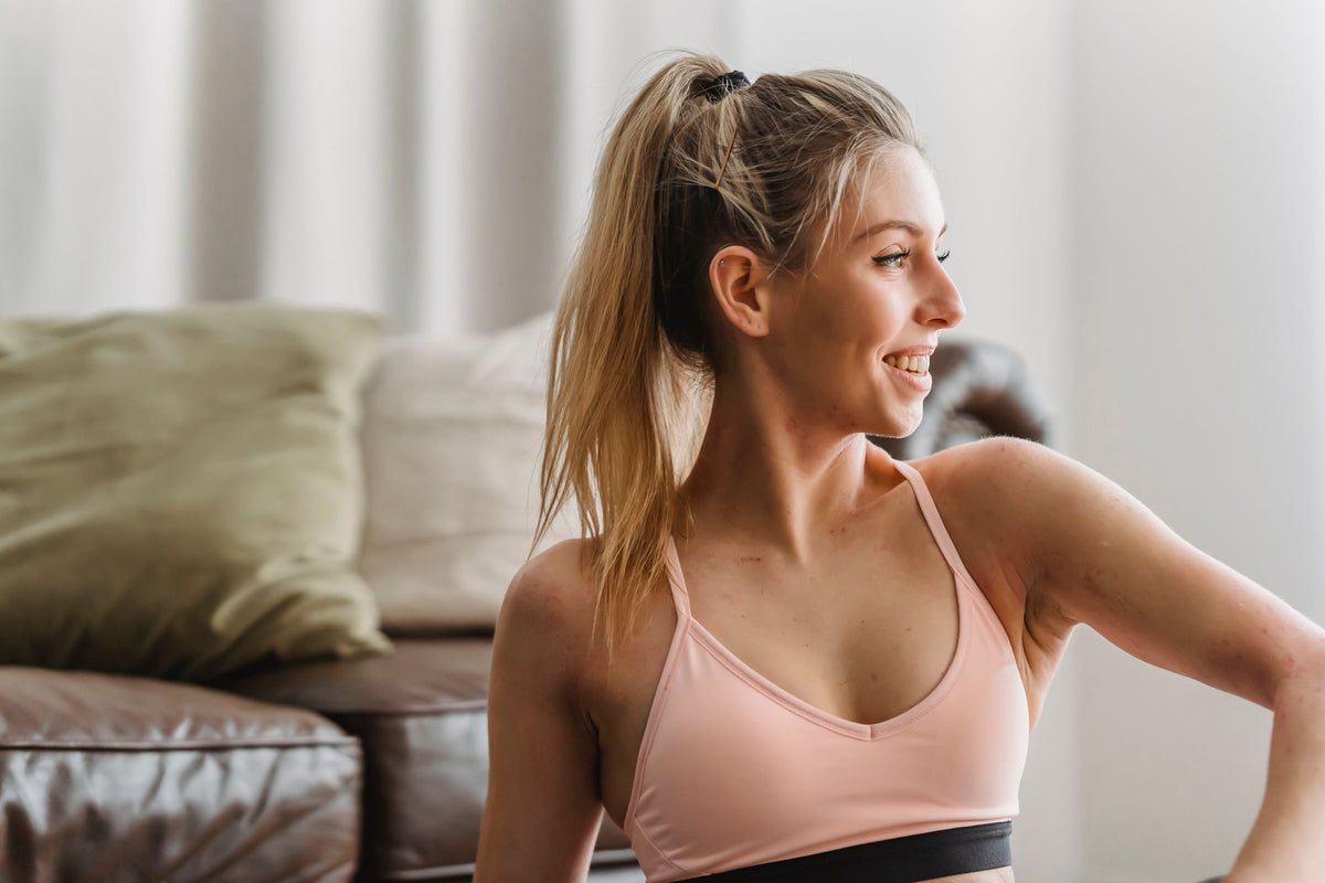 Smiling woman taking a break during an at-home workout